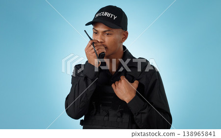 Security guard, walkie talkie and man with communication in a studio with police and law enforcement. Blue background, surveillance and officer with discussion and talking for safety and danger 138965841