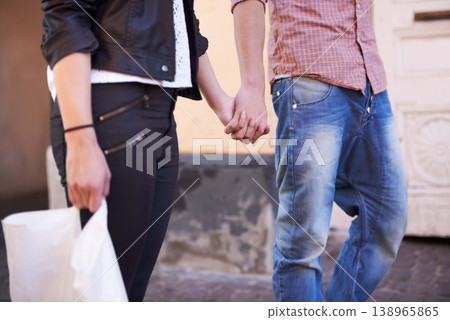 Zoom, shopping and couple holding hands in a city for sale, travel or weekend freedom. Retail, customer or closeup on people together in New York street for store, deal or bonding over discount offer 138965865