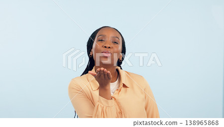 Love, black woman and blowing a kiss in portrait, studio and blue background with flirting or romance. Lips, pouting and gen z person or emoji with confidence, happiness and mock up space with care Love, black woman and blowing a kiss in portrait, studio and blue background with flirting or romance. Lips, pouting and gen z person or emoji with confidence, happiness and mock up space with care 138965868