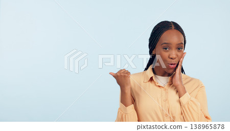 Woman, point and gossip in studio with space for mockup, portrait and review by blue background. African girl, news or story with presentation, promotion and announcement with secret, info or offer 138965878
