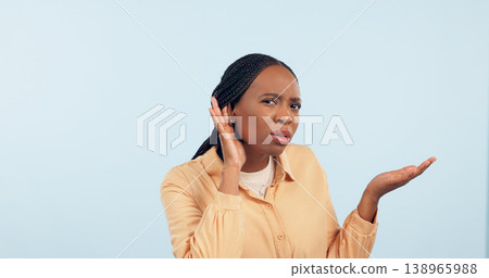 Woman, hand and ear in studio for story, gossip and frustrated face in portrait by blue background. African girl, hearing and confused for secret information, news and communication with questions 138965988