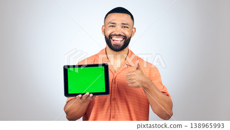 Portrait, man and thumbs up for tablet with green screen, space or agreement of deal in studio on white background. Happy model, digital marketing and like emoji for newsletter, promotion and support Portrait, man and thumbs up for tablet with green screen, space or agreement of deal in studio on white background. Happy model, digital marketing and like emoji for newsletter, promotion and support 138965993