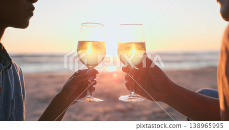 Sunset, beach and couple with wine, toast and anniversary with happiness, marriage and vacation. Romance, man and woman with alcohol, cheers or relationship with seaside holiday, lens flare or luxury Sunset, beach and couple with wine, toast and anniversary with happiness, marriage and vacation. Romance, man and woman with alcohol, cheers or relationship with seaside holiday, lens flare or luxury 138965995
