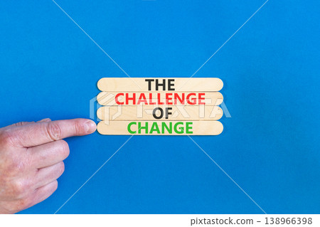 The challenge of change symbol. Concept words The challenge of change on beautiful wooden sticks. Beautiful blue background. Businessman hand. Business the challenge of change concept. Copy space. The challenge of change symbol. Concept words The challenge of change on beautiful wooden sticks. Beautiful blue background. Businessman hand. Business the challenge of change concept. Copy space. 138966398