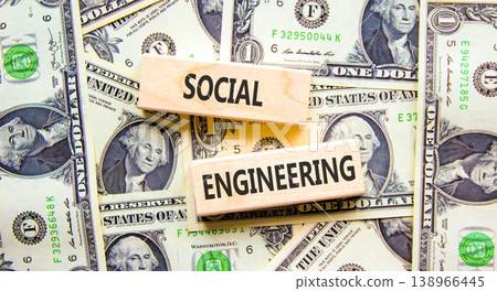 Social engineering words symbol. Concept words Social engineering on beautiful wooden blocks. Beautiful dollar bills background. Dollar bills. Business and Social engineering words concept. Copy space Social engineering words symbol. Concept words Social engineering on beautiful wooden blocks. Beautiful dollar bills background. Dollar bills. Business and Social engineering words concept. Copy space 138966445