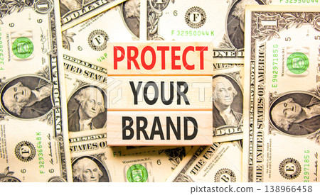 Protect your brand words symbol. Concept words Protect your brand on beautiful wooden blocks. Beautiful dollar bills background. Dollar bills. Business and protect your brand concept. Copy space. Protect your brand words symbol. Concept words Protect your brand on beautiful wooden blocks. Beautiful dollar bills background. Dollar bills. Business and protect your brand concept. Copy space. 138966458