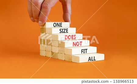 One size does not fit all symbol. Concept words One size does not fit all on wooden stick. Beautiful orange background. Businessman hand. One size does not fit all business concept. Copy space. One size does not fit all symbol. Concept words One size does not fit all on wooden stick. Beautiful orange background. Businessman hand. One size does not fit all business concept. Copy space. 138966513