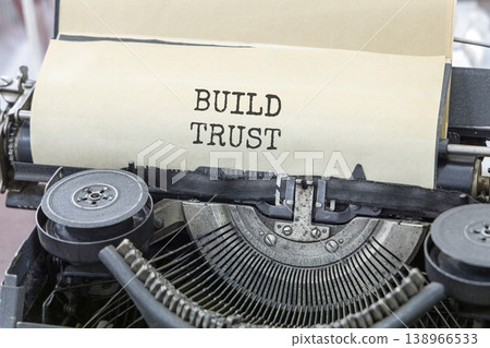 Build trust symbol. Concept words Build trust typed on beautiful old retro typewriter. Beautiful white paper background. Business and build trust concept, copy space. Build trust symbol. Concept words Build trust typed on beautiful old retro typewriter. Beautiful white paper background. Business and build trust concept, copy space. 138966533