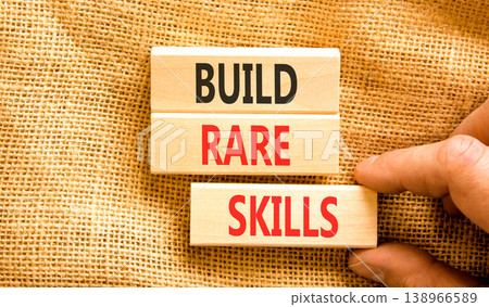 Build rare skills words symbol. Concept words Build rare skills on beautiful wooden blocks. Beautiful canvas background. Businessman hand. Business and build rare skills concept. Copy space. 138966589