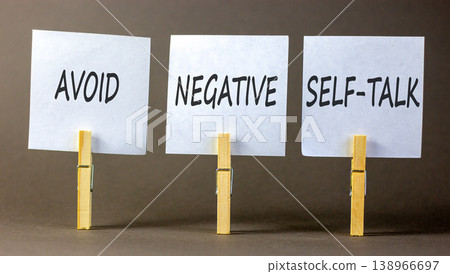 Avoid negative self-talk symbol. Concept words Avoid negative self-talk on beautiful papers on clothespin. Beautiful grey background. Business psychology avoid negative self-talk concept. Copy space 138966697