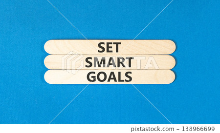 Set smart goals words symbol. Concept words Set smart goals on beautiful wooden sticks. Beautiful blue background. Business and set smart goals concept. Copy space. Set smart goals words symbol. Concept words Set smart goals on beautiful wooden sticks. Beautiful blue background. Business and set smart goals concept. Copy space. 138966699