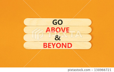 Go above and beyond words symbol. Concept words Go above and beyond on beautiful wooden sticks. Beautiful orange background. Business motivational Go above and beyond concept. Copy space. Go above and beyond words symbol. Concept words Go above and beyond on beautiful wooden sticks. Beautiful orange background. Business motivational Go above and beyond concept. Copy space. 138966721