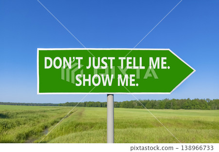 Tell or show symbol. Concept words Do not just tell me, show me beautiful green road sign. Beautiful blue sky green field background. Business tell or show concept. Copy space. Tell or show symbol. Concept words Do not just tell me, show me beautiful green road sign. Beautiful blue sky green field background. Business tell or show concept. Copy space. 138966733