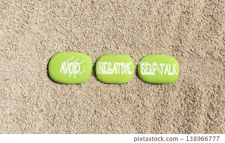 Avoid negative self-talk symbol. Concept words Avoid negative self-talk on beautiful green stones. Beautiful sand beach background. Business psychology avoid negative self-talk concept. Copy space. Avoid negative self-talk symbol. Concept words Avoid negative self-talk on beautiful green stones. Beautiful sand beach background. Business psychology avoid negative self-talk concept. Copy space. 138966777