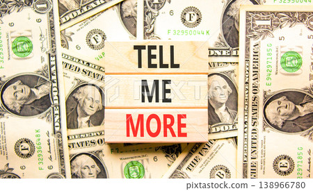 Tell me more words symbol. Concept words Tell me more on beautiful wooden blocks. Beautiful dollar bills background. Dollar bills. Business and tell me more concept. Copy space. 138966780