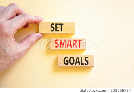 Set smart goals words symbol. Concept words Set smart goals on beautiful wooden blocks. Beautiful white background. Businessman hand. Business and set smart goals concept. Copy space. Set smart goals words symbol. Concept words Set smart goals on beautiful wooden blocks. Beautiful white background. Businessman hand. Business and set smart goals concept. Copy space. 138966784