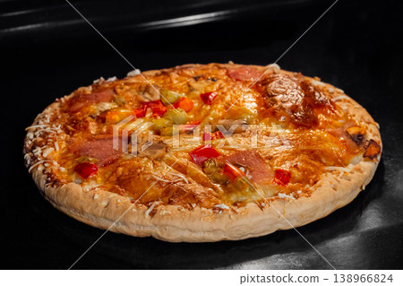 Burnt homemade pizza on tray in electric oven 138966824