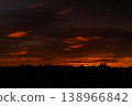 Colorful sunrise over city and dramatic sky with orange clouds 138966842