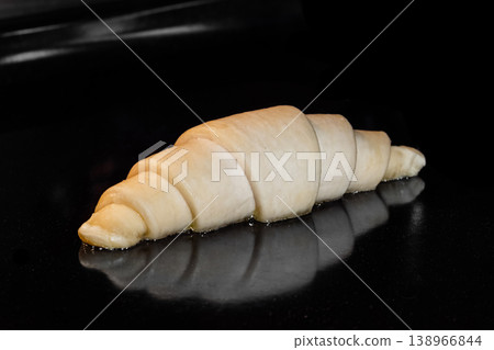 Homemade croissant baking and rising in electric oven: close up Homemade croissant baking and rising in electric oven: close up 138966844