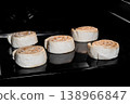Five uncooked cinnamon buns on tray in electric oven, black background 138966847
