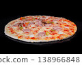 Uncooked homemade pizza on tray in electric oven, black background 138966848
