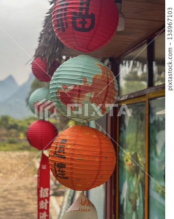 Colorful lanterns hang against misty mountains Colorful lanterns hang against misty mountains 138967103