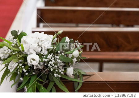 White flowers decorating pews in church interior White flowers decorating pews in church interior 138967198