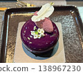Elegant purple dessert with flower on black plate 138967230