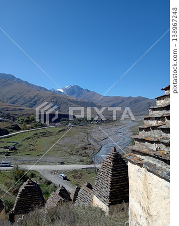 City of the Dead necropolis, Dargavs, North Ossetia, Russia. Stone mausoleums scattered across the hillside under open sky City of the Dead necropolis, Dargavs, North Ossetia, Russia. Stone mausoleums scattered across the hillside under open sky 138967248