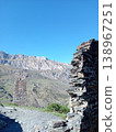 Ruins of the Kurta and Taga signal tower, North Ossetia, Russia. Crumbling stone walls of an ancient Alan watchtower on a green mountain slope 138967251