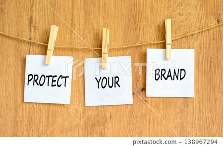 Protect your brand words symbol. Concept words Protect your brand on beautiful white papers on wooden clothespin. Beautiful wooden background. Business and protect your brand concept. Copy space. Protect your brand words symbol. Concept words Protect your brand on beautiful white papers on wooden clothespin. Beautiful wooden background. Business and protect your brand concept. Copy space. 138967294