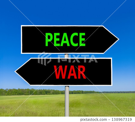 Peace instead war symbol. Concept words Peace and War on beautiful black road sign. Beautiful blue sky green grass background. Social and peace instead war concept. Copy space. Peace instead war symbol. Concept words Peace and War on beautiful black road sign. Beautiful blue sky green grass background. Social and peace instead war concept. Copy space. 138967319