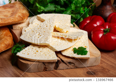 Georgian sliced cheese,on a wooden chopping board, with tomatoes with herbs and lavash, rustic style, Georgian cuisine, no people Georgian sliced cheese,on a wooden chopping board, with tomatoes with herbs and lavash, rustic style, Georgian cuisine, no people 138967466