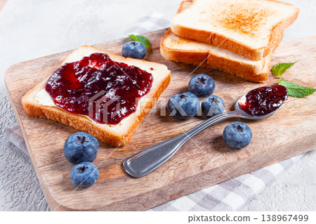 toast with blueberry jam, on a wooden chopping board, breakfast, homemade, no people, toast with blueberry jam, on a wooden chopping board, breakfast, homemade, no people, 138967499
