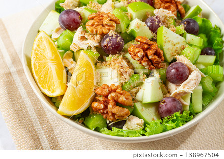Fresh Waldorf salad, celery stalk with chicken, apple and walnuts, grapes, herbs, homemade, without people, Fresh Waldorf salad, celery stalk with chicken, apple and walnuts, grapes, herbs, homemade, without people, 138967504