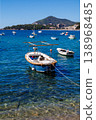 Vertical view of small boat floating on crystal clear sea water with visible seabed, Adriatic coast landscape, summer travel destination, peaceful marine scene 138968485