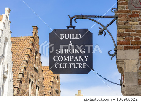 Strong company culture symbol. Concept words Build a strong company culture on beautiful black road sign. Beautiful blue sky background. Business strong company culture concept. Copy space. 138968522