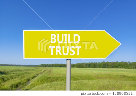 Build trust symbol. Concept words Build trust on beautiful yellow road sign. Beautiful blue sky green grass field background. Business and build trust concept, copy space. Build trust symbol. Concept words Build trust on beautiful yellow road sign. Beautiful blue sky green grass field background. Business and build trust concept, copy space. 138968531