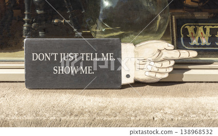 Tell or show symbol. Concept words Do not just tell me, show me beautiful wooden black sign. Beautiful store front background. Business tell or show concept. Copy space. Tell or show symbol. Concept words Do not just tell me, show me beautiful wooden black sign. Beautiful store front background. Business tell or show concept. Copy space. 138968532