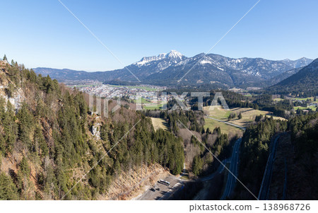 Snowy mountain peak rising above forest in Bavaria Germany on a clear winter day Snowy mountain peak rising above forest in Bavaria Germany on a clear winter day 138968726