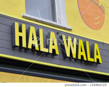 London uk 05.07.2025 Hala Wala restaurant sign with bright yellow lettering on modern facade of casual dining venue in vibrant urban street setting London uk 05.07.2025 Hala Wala restaurant sign with bright yellow lettering on modern facade of casual dining venue in vibrant urban street setting 138968729
