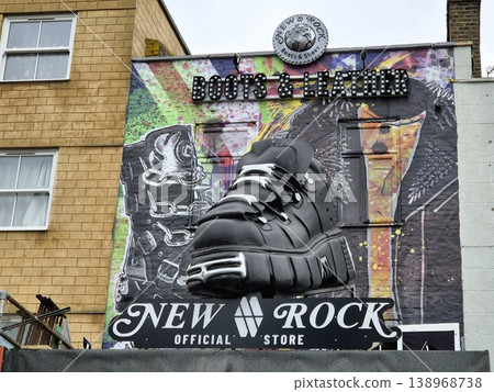 London UK 05.07.2025 New Rock boots and leather store facade with large shoe sculpture and colorful graffiti background showcasing bold fashion style and alternative culture in Camden street 138968738