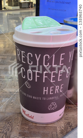 London UK - 07.01.2025 Recycling bin in the shape of a coffee cup located inside a shopping mall, with labeled slots for lids, liquids, and coffee cups promoting zero waste and environmental London UK - 07.01.2025 Recycling bin in the shape of a coffee cup located inside a shopping mall, with labeled slots for lids, liquids, and coffee cups promoting zero waste and environmental 138968740