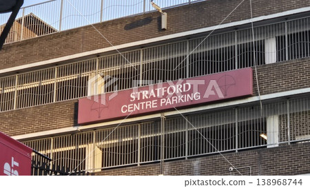 London UK - 07.01.2025 Stratford centre parking sign on multi storey car park facade with urban architecture and city infrastructure in evening sunlight London UK - 07.01.2025 Stratford centre parking sign on multi storey car park facade with urban architecture and city infrastructure in evening sunlight 138968744