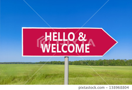 Hello and welcome symbol. Concept words Hello and welcome on beautiful red road sign. Beautiful blue sky green grass field background. Business hello and welcome concept. Copy space. 138968804