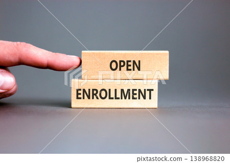 Open enrollment words symbol. Concept words Open enrollment on beautiful wooden blocks. Beautiful grey background. Doctor hand. Medical and Open enrollment words concept. Copy space. 138968820