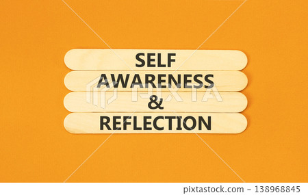 Self awareness and reflection symbol. Concept words Self awareness and reflection on beautiful wooden sticks. Beautiful orange background. Psychological self awareness reflection concept. Copy space. 138968845