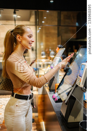 Woman ordering food at self-service kiosk in Vienna 138968895