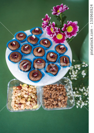 Healthy energy balls on serving platter with nuts and flower decoration Healthy energy balls on serving platter with nuts and flower decoration 138968924
