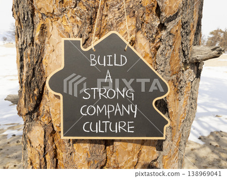 Strong company culture symbol. Concept words Build a strong company culture on beautiful black blackboard. Beautiful old pine tree background. Business strong company culture concept. Copy space. Strong company culture symbol. Concept words Build a strong company culture on beautiful black blackboard. Beautiful old pine tree background. Business strong company culture concept. Copy space. 138969041